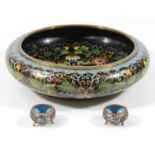 A Chinese late Qing period enamel bowl, of circular compressed outline, decorated with scrolls and