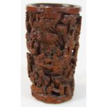 A late 19thC Chinese Qing period bamboo brush pot, the cylindrical body heavily carved with