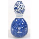 A Chinese porcelain Kangxi style double gourd vase, in blue and white decoration with an upper