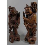 Two Chinese hardwood figures, each partially stained, the first a bearded sage holding fish on