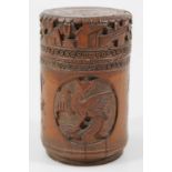 A late 19thC Chinese bamboo jar and cover, the heavily carved lid raised above a cylindrical body