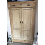 A 19thC stripped pine continental armoire.