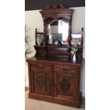 A late Victorian carved walnut chiffonier with mirrorback.