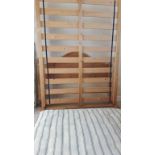 A modern pine double bedstead.