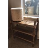 A pine three tier buffet, linen basket and a candlestand.