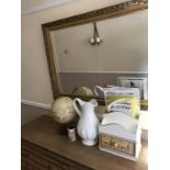 A rectangular gilt framed wall mirror, table globe, large jug and book rack, (4).