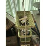 A three tier wicker rack and contents of plated cutlery.