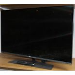 A Phillips 42" colour flat screen television, in chrome trim, on stand.
