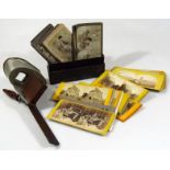 A stereoscopic viewer, with wooden and metal mounts, 19cm high and a quantity of various cards, to