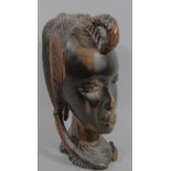 An early 20thC African tribal hardwood head, heavily carved, formed as a lady, probably in tiger