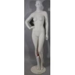 *A modern tailor's mannequin dummy, female, full profile on circular metal stand, painted cream,