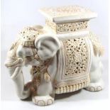 A 20thC Chinese pottery plant stand, in the form of an elephant wearing heavy tack, of part