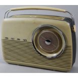 A mid 20thC retro Bush radio, with articulated handle and grille speaker front with raised