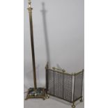 A brass Corinthian column standard lamp, with electrical fitting and a three fold fire guard, (2)