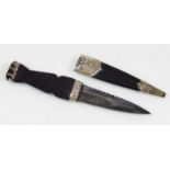 *A Scottish Sgian-dubh knife, with leather scabbard, the moulded handle mounted Cairngorm, the