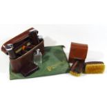 A mid 20thC leather cased travelling box set, comprising cylindrical powder boxes, etc., two leather