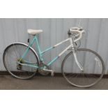 A ladies Raleigh Impulse 12 speed racer bicycle, in turquoise, white, yellow and purple, with