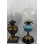 An early 20thC brass oil lamp, with frosted and clear glass shade, clear glass reservoir, moulded