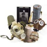 Two gas masks in fitted tins, 54cm high, and a book The SS. (3)