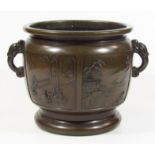 A Japanese Meiji period bronze jardiniere, of circular outline with interior panels set with