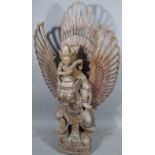 A modern wooden carving of an Indian god group, possibly Shiva, with a figural god with pierced
