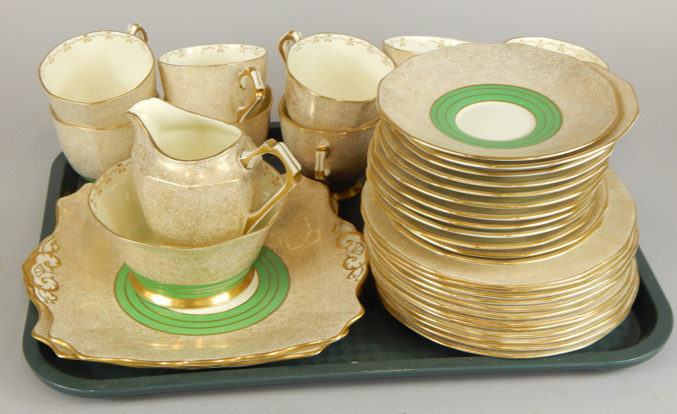 A Tuscan plant Art Deco style part tea service, to include ten cups and saucers, each decorated in
