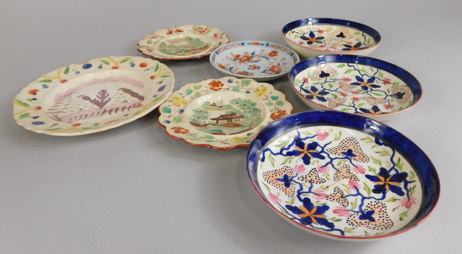 A collection of ceramics, to include children's plates, two saucers, decorated with flowers in