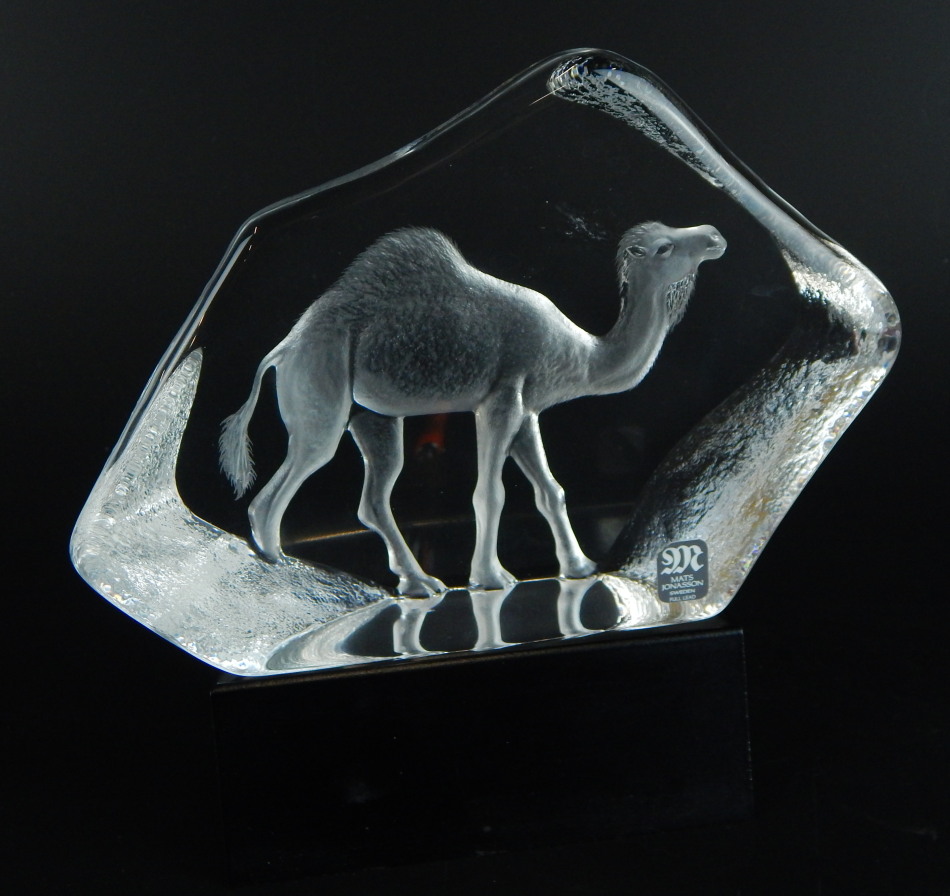 A Mats Johansson Swedish glass paperweight, modelled with a camel on a rectangular base, 17cm wide.