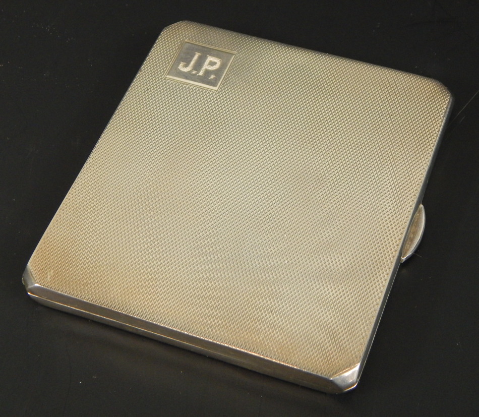 A George V silver cigarette case, with engine turned design body, with initials JP, Birmingham 1933,