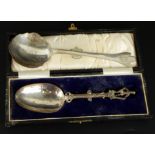 Two silver spoons, to include a trefid serving spoon, marked T.G.C. and bearing crest, Sheffield