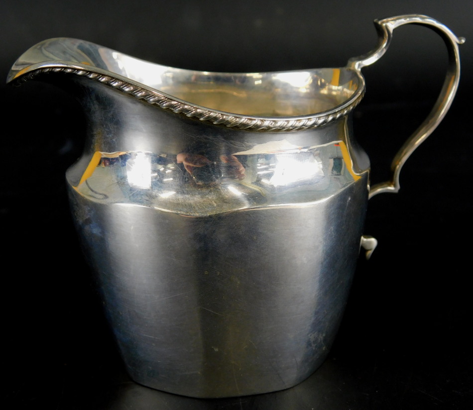 A George V silver milk jug, of fluted form, with reeded border, an acanthus leaf handle,