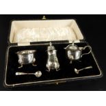 A George V silver cruet set, of plain fluted form, with claw feet, in a fitted case, Birmingham