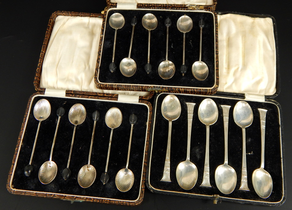 Three cased sets of silver teaspoons, comprising a set of six coffee bean silver spoons, a set of