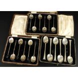 Three cased sets of silver teaspoons, comprising a set of six coffee bean silver spoons, a set of