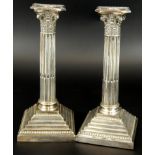 A pair of George V silver Corinthian column table candlesticks, on reeded and fluted stem, with