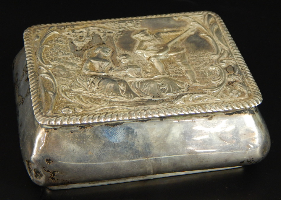 A Victorian silver trinket box, with embossed decoration of man playing guitar, with reeded