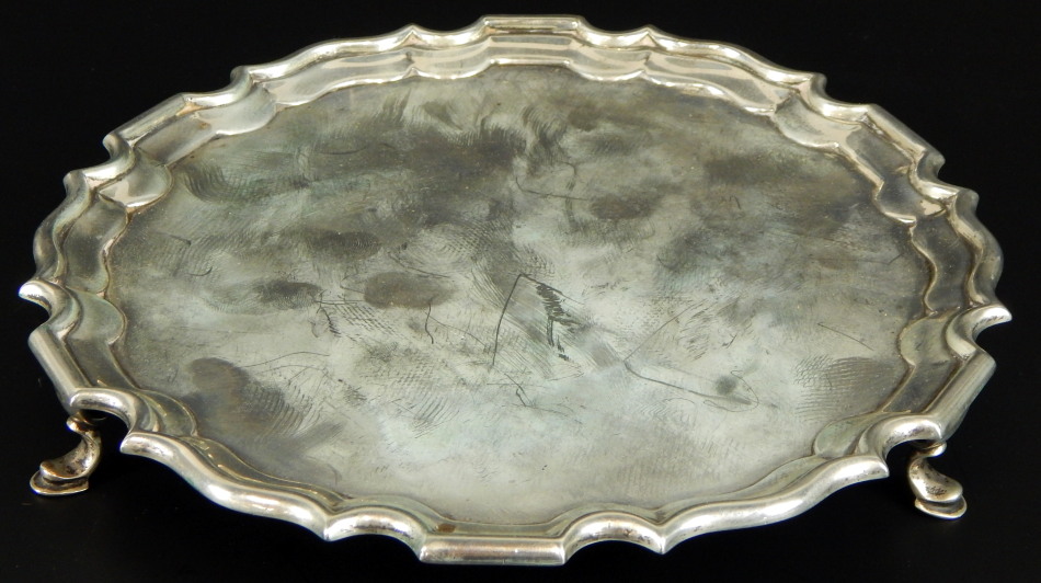 A George V silver salver, with gadrooned border, and bun feet, Birmingham 1927, 12oz, 20cm dia. (M)