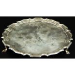 A George V silver salver, with gadrooned border, and bun feet, Birmingham 1927, 12oz, 20cm dia. (M)