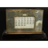 An Art Deco silver and mahogany desk calendar, Birmingham 1936, 17cm wide. (M)