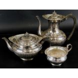 An Edwardian Walker & Hall silver three piece tea service, comprising coffee pot, 23cm high, teapot,