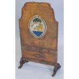 An unusual early 20thC brown leather firescreen, embellished with a panel depicting the Oakham and