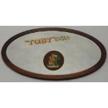 A mid 20thC pub mirror, advertising Toby Ales and Stout, with a bevelled plate and mahogany