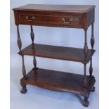 An early 20thC mahogany three tier whatnot or buffet, the top with a moulded edge above a frieze