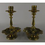 A pair of 19thC brass candlesticks, of turned form, with shell cast bases, impressed marks to
