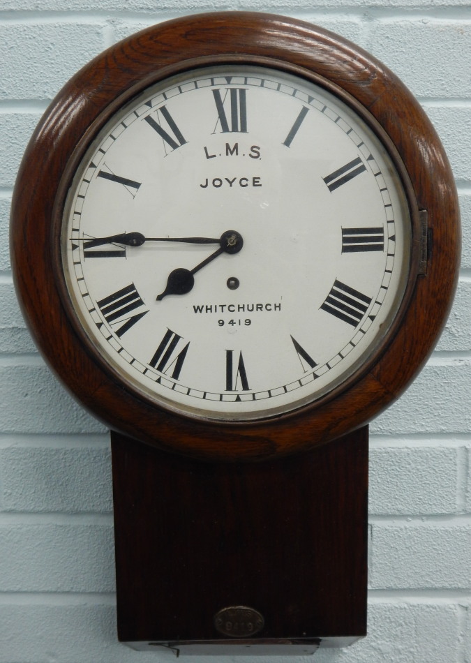 A late 19thC oak and pine railway drop dial wall clock, the white dial painted for L.M.S. by Joyce