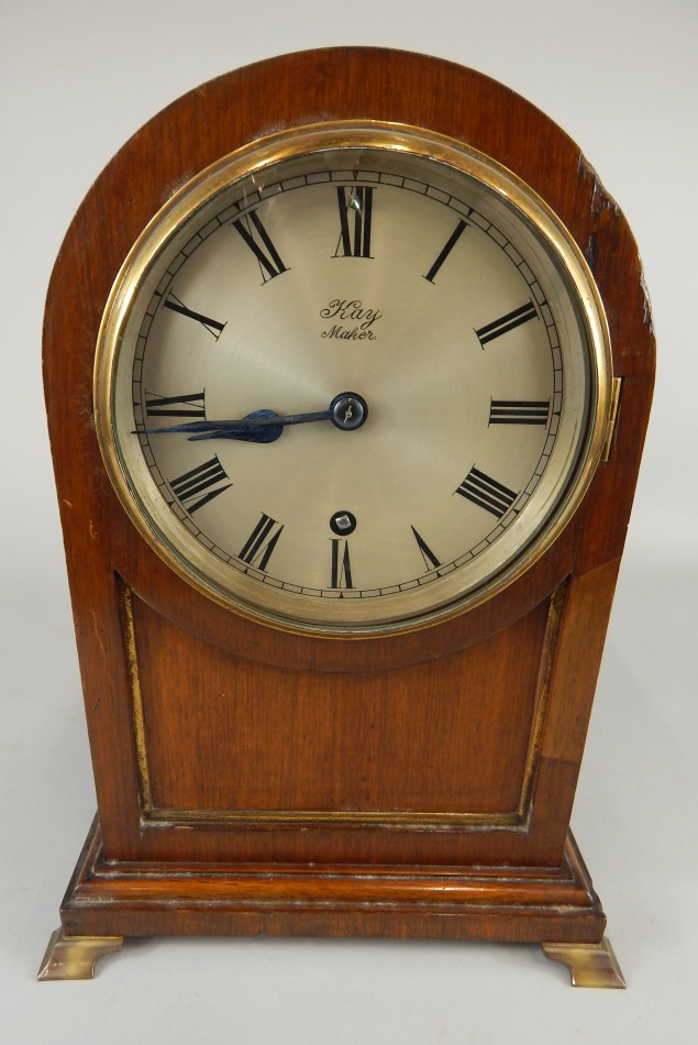 A late 19th/early 20thC mahogany and brass mantel clock, the silvered dial stamped K Maker, with