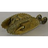 A brass apprentice type model of a First World War tank, mounted to the reverse with carriage