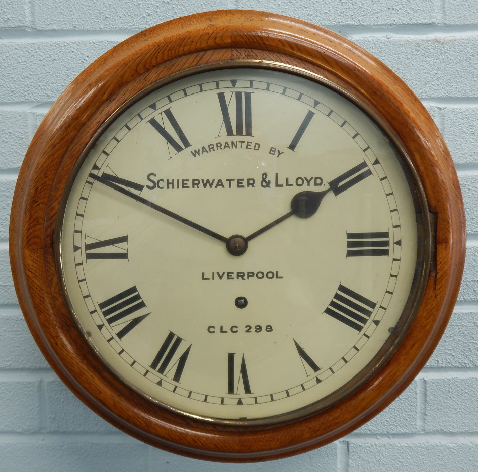 A late 19th/early 20thC oak railway wall clock, the white dial bearing inscription 'warranted by