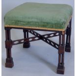 A mahogany foot stool, in the manner of Thomas Chippendale, with pilaster column supports, pierced