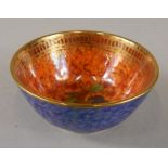 A Wedgwood lustre miniature bowl, decorated with fruit to the interior, with an orange mottled glaze